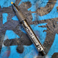 Pentel bullet point paint marker in black on a colored background