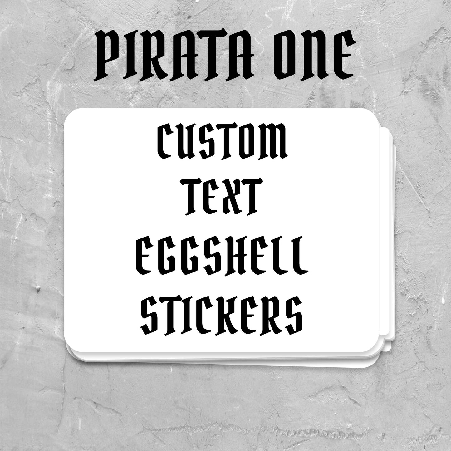 A stack of white custom eggshell stickers with black gothic-style text reading 'PIRATA ONE' and 'CUSTOM TEXT EGGSHELL STICKERS'.