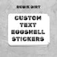 Stack of custom text eggshell stickers on a textured gray background with 'Rubik Dirt' branding.