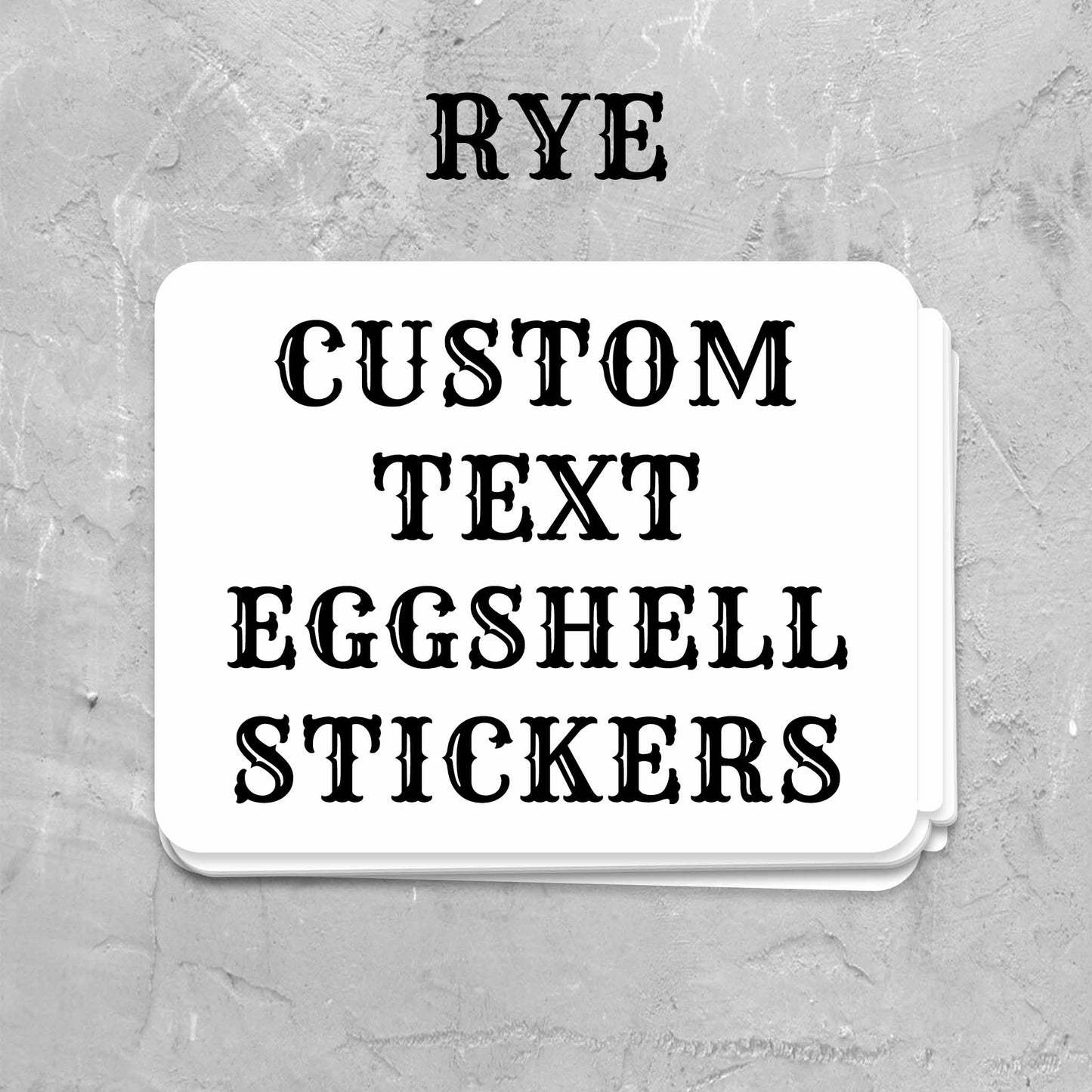 A stack of white rectangular stickers with black decorative text reading 'CUSTOM TEXT EGGSHELL STICKERS' and the word 'RYE' appears in black serif font, suggesting a customizable product listing.