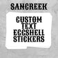 A stack of white custom eggshell stickers with black gothic-style text reading 'SANCREEK' and 'CUSTOM TEXT EGSHELL STICKERS' on a textured gray background.