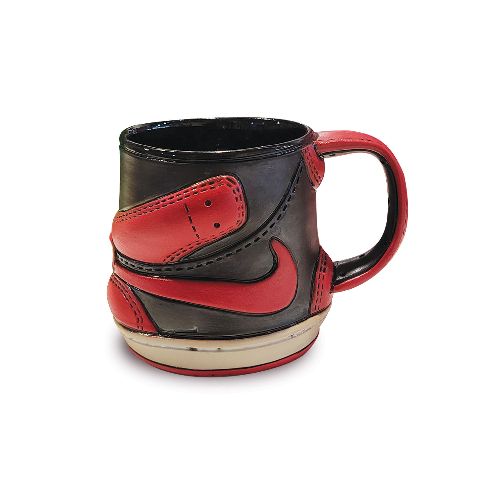Black and red Nike shoe-shaped mug on a white background.
