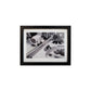 Black framed black and white photo of a bathroom.