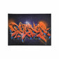 A black canvas with bright orange graffiti style letters painted.