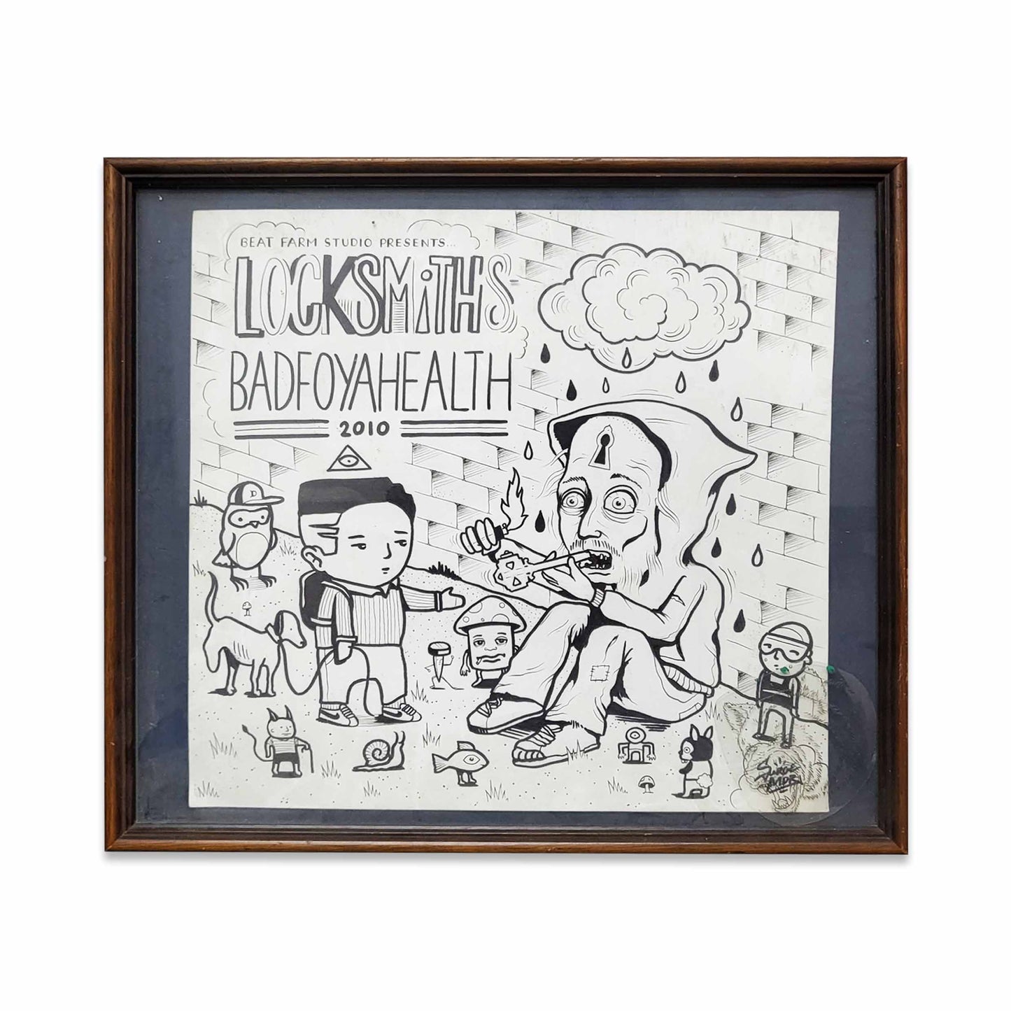 A framed black and white drawing of a man reaching out to another man wearing a hood with writing ' LockSmiiths Badfoyahealth 2010'.