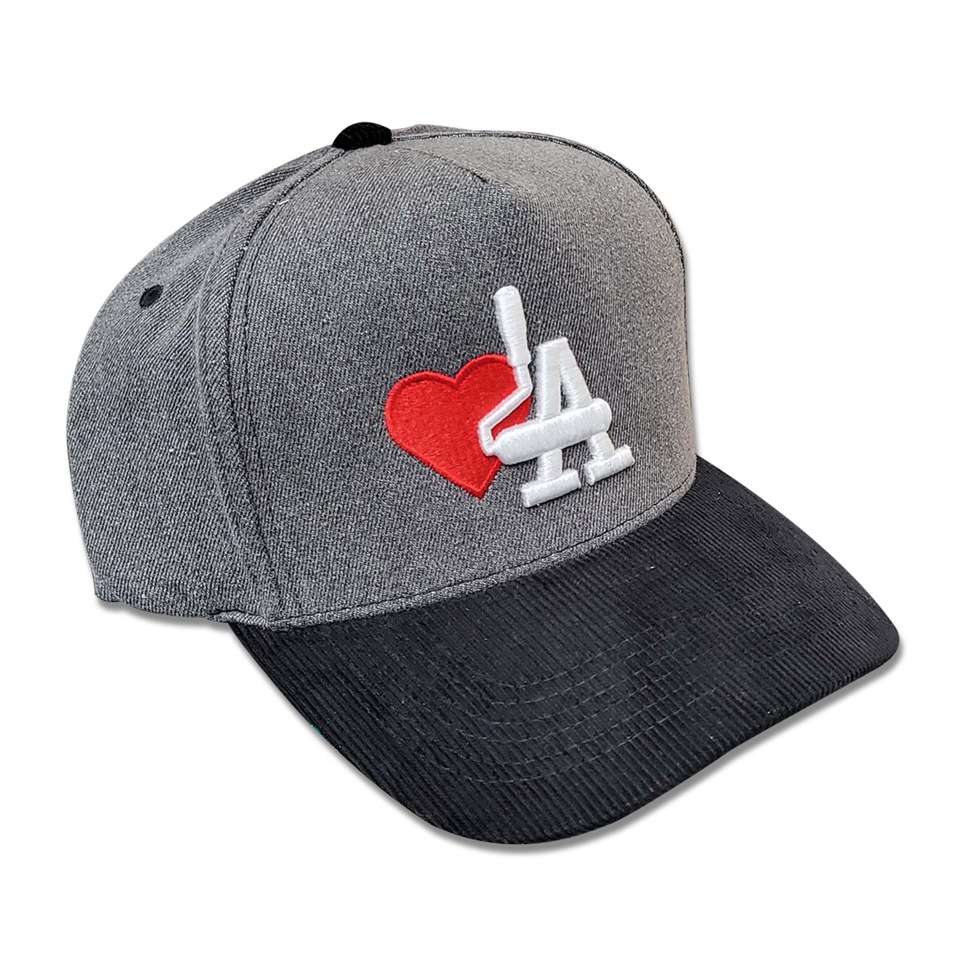Grey hat with black corduroy and white embroidery of paint rollers in the shape of the acronym LA and a red heart.