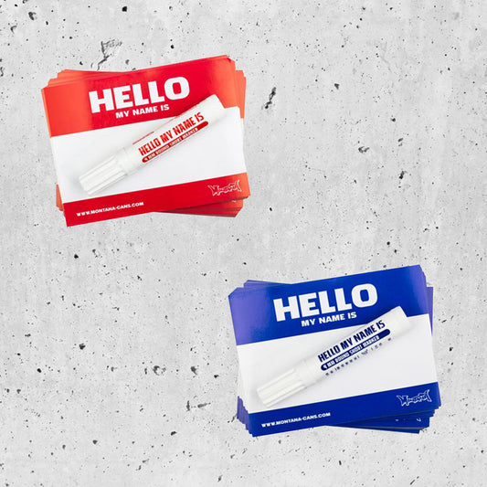 Red and Blue "hello my name is" Montana can sticker packs with marker to match on a concrete background