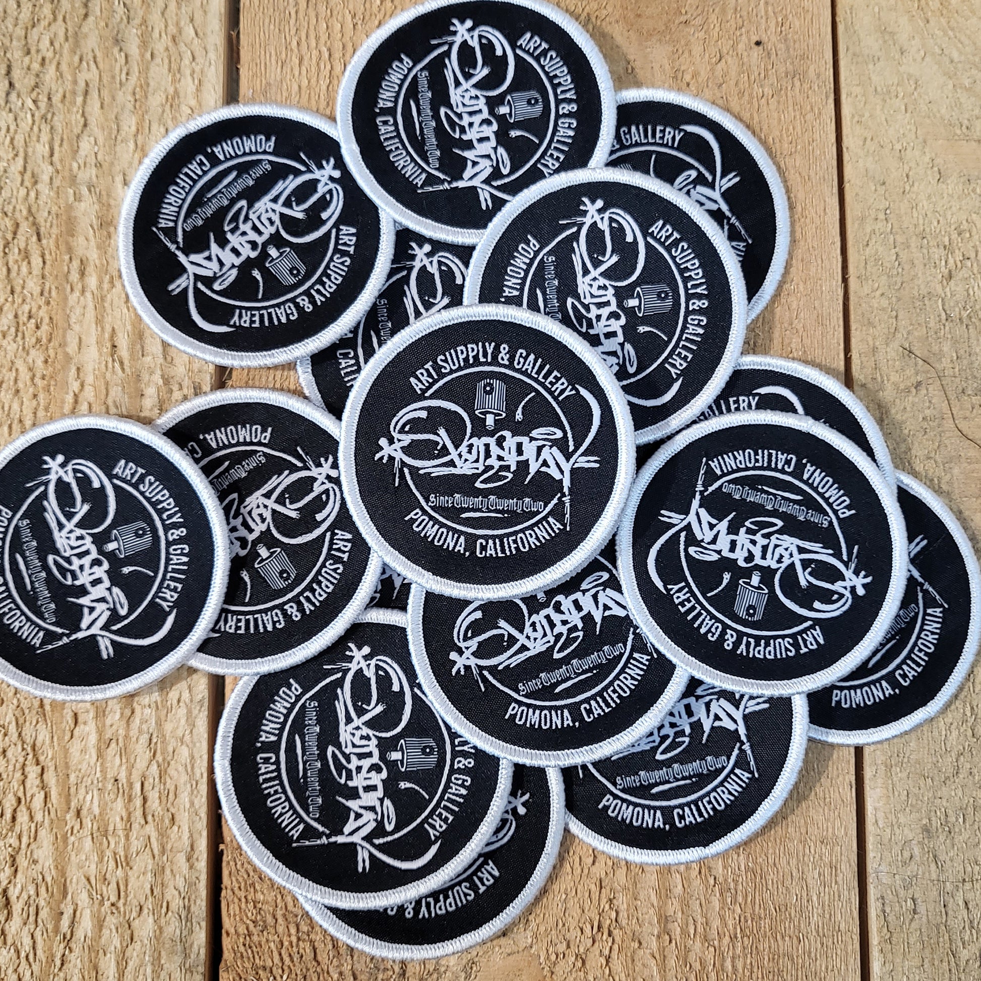 round black overspray tag patch with a silver edge