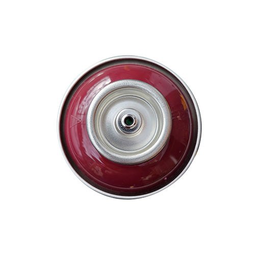 The top of a spray paint can, with a dark red color swatch in the middle of the silver, metal rings of the can.