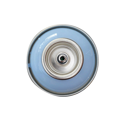 The top of a spray paint can, with a pastel blue color swatch in the middle of the silver, metal rings of the can.