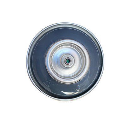 The top of a spray paint can, with a dark blue grey color swatch in the middle of the silver, metal rings of the can.