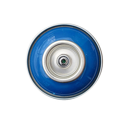 The top of a spray paint can, with a bright blue color swatch in the middle of the silver, metal rings of the can.